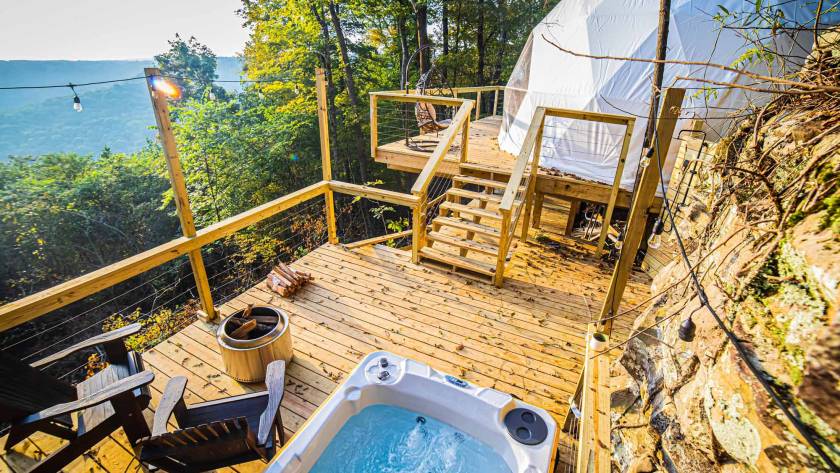 glamping dome and hot tub on a deck with mountain views